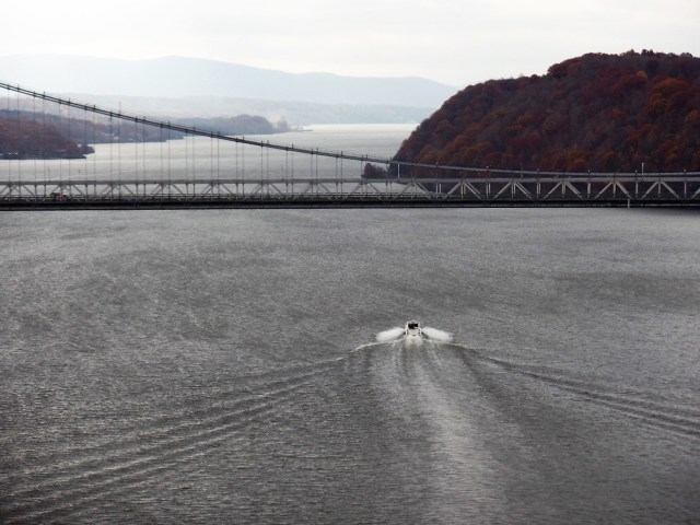 Boat heading under bridge