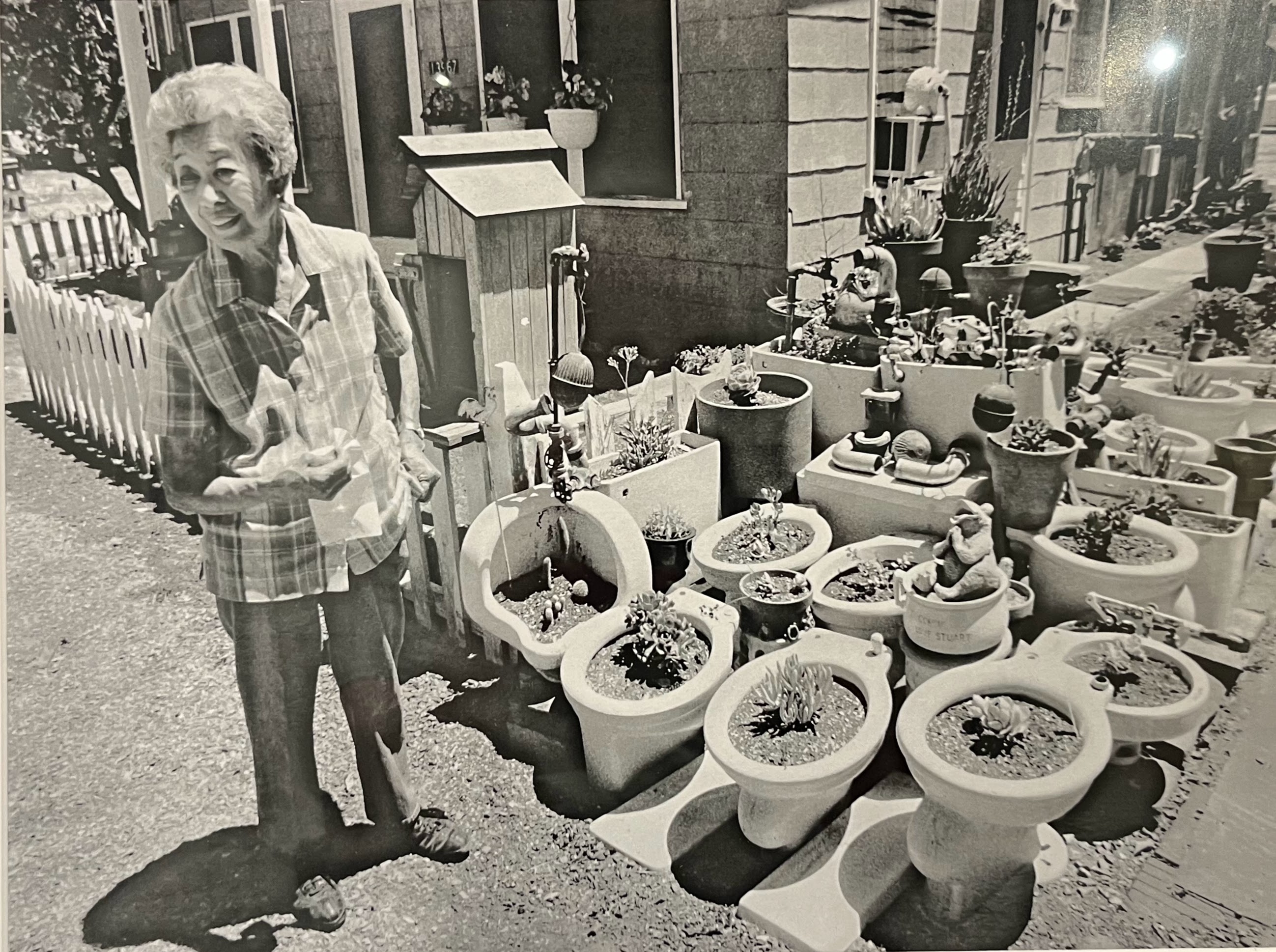 Connie King, 'honorary mayor' of Locke, Calif., shows her Demonstration Garden of toilet bowls discarded by white people who did not want to sit where Chinese had sat, 2007.
